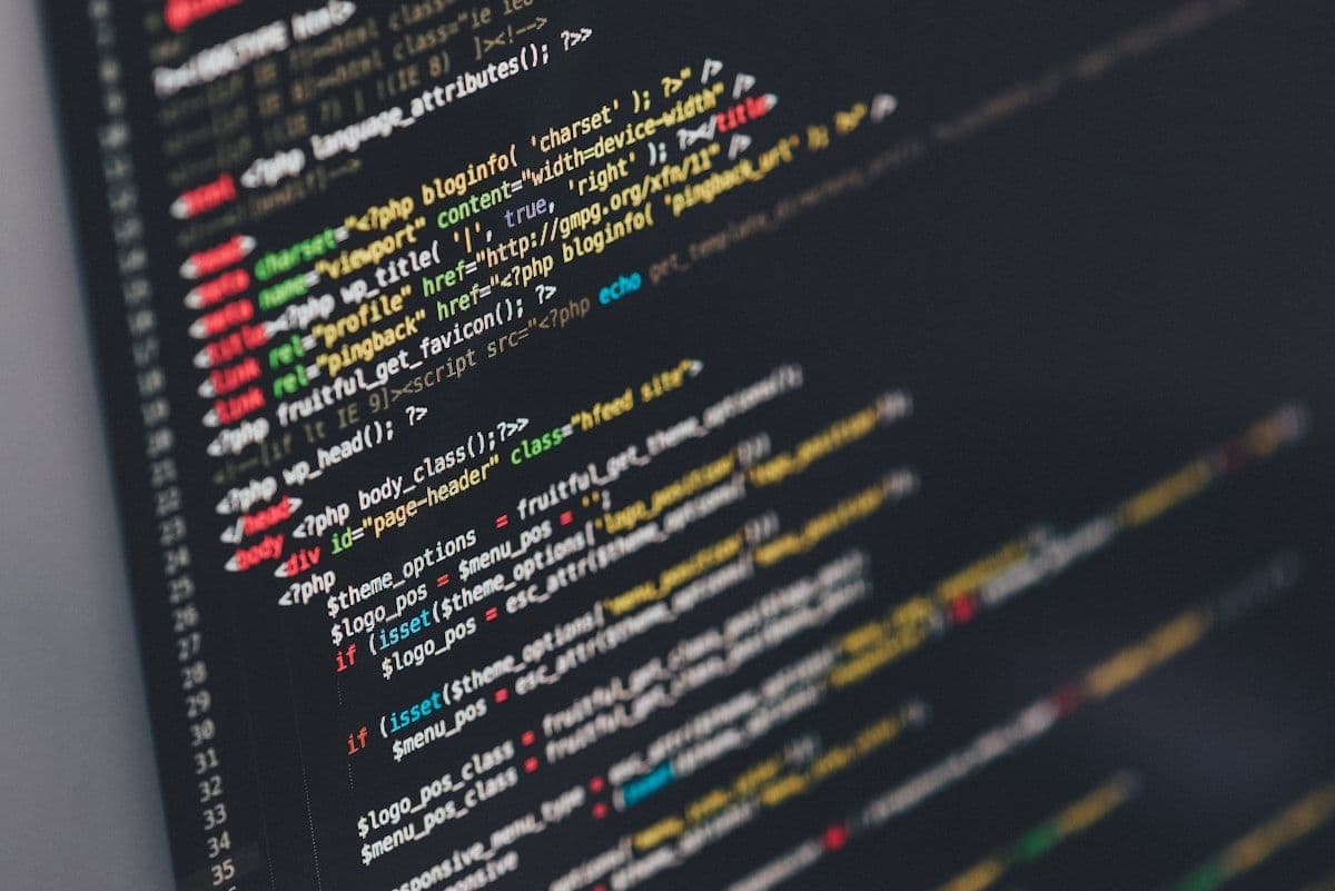 Laptop screen showing full website codebase and terminal